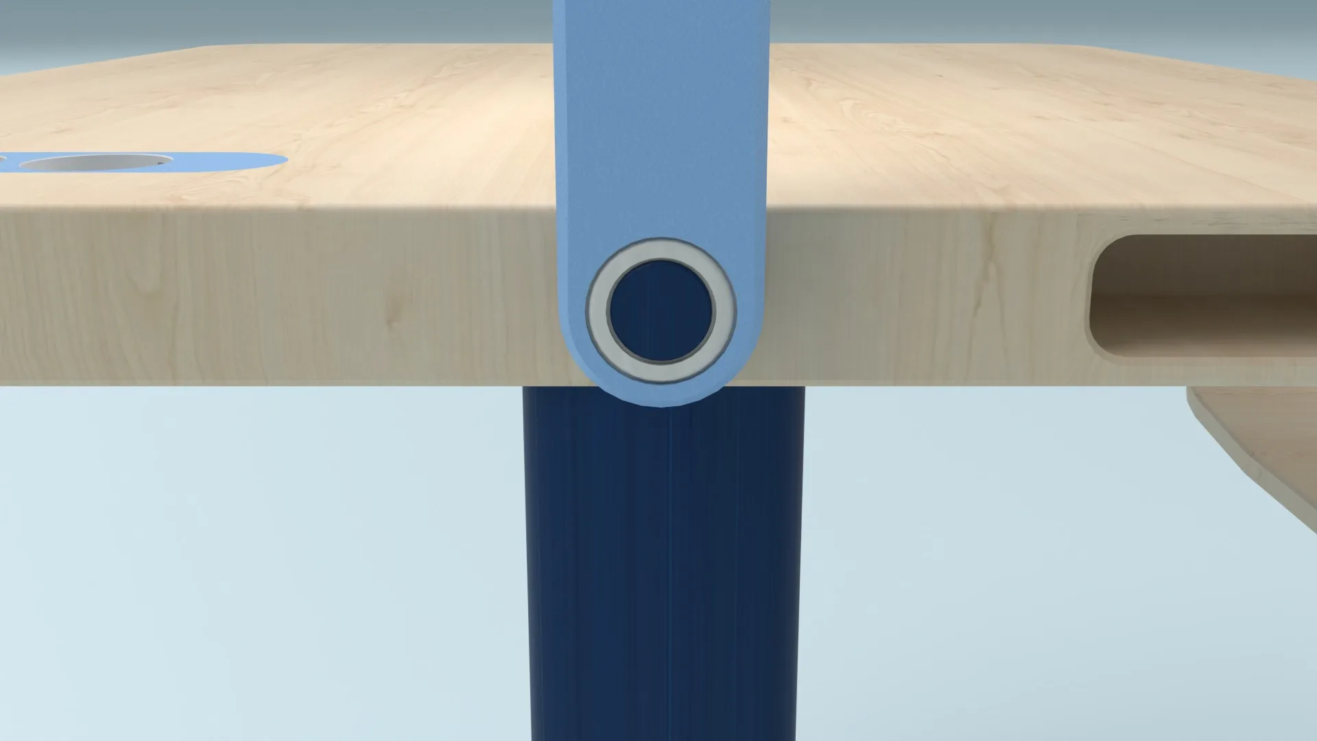 Detail: the height button set into the blue leg under the desk top
