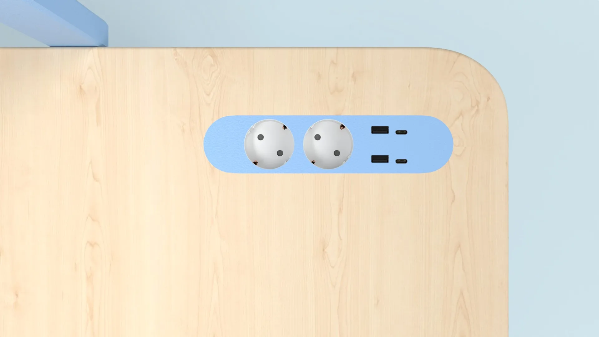 Detail: two sockets and two USB ports set into the corner of the desk top