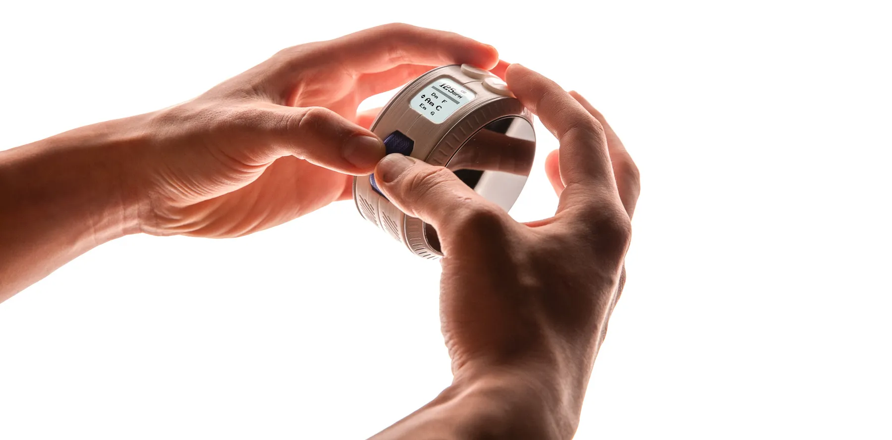 Hands holding a white printed model of Senzu to check size and grip