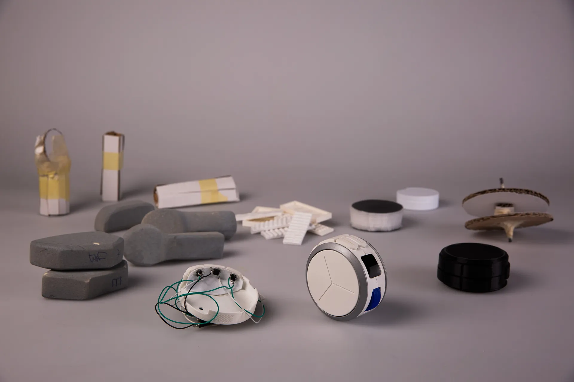 Foam, paper and printed models lined up on a grey backdrop
